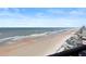 Stunning ocean view from condo balcony, showing beach and coastline at 1420 N Atlantic Ave # 1102, Daytona Beach, FL 32118