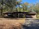 Brick ranch home with a carport and mature trees at 1525 S Hayden Rd, Deland, FL 32724