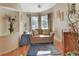 Relaxing sitting area in the main bedroom with a comfy couch and large windows at 1575 Covered Bridge Dr, Deland, FL 32724