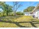 Large backyard with grassy area and trees at 1612 Beatrice Dr, Orlando, FL 32810