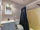 Bathroom with gray vanity, toilet and shower/tub at 1612 Beatrice Dr, Orlando, FL 32810