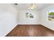 Well lit bedroom with wood-look flooring and two windows at 1612 Beatrice Dr, Orlando, FL 32810