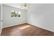 Bright bedroom featuring wood-look flooring and a window at 1612 Beatrice Dr, Orlando, FL 32810