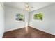 Spacious bedroom with hardwood floors and two windows at 1612 Beatrice Dr, Orlando, FL 32810