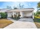 White single story home with covered carport and landscaping at 1612 Beatrice Dr, Orlando, FL 32810