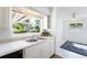 Kitchen with white cabinets, double sink and window at 1612 Beatrice Dr, Orlando, FL 32810