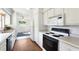 White kitchen with an electric stove and built in microwave at 1612 Beatrice Dr, Orlando, FL 32810