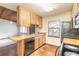 Kitchen area with wood cabinets, black appliances, and a dishwasher at 1668 Spring Garden Ct # 1668, Daytona Beach, FL 32117