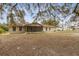Backyard view showcasing a screened patio and expansive yard space at 1870 S Lehigh Dr, Deltona, FL 32738