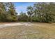 Expansive backyard featuring mature trees and a concrete slab, ideal for outdoor activities at 1870 S Lehigh Dr, Deltona, FL 32738