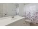 Bathroom features vanity with a large mirror and floral patterned shower curtain at 1870 S Lehigh Dr, Deltona, FL 32738