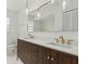 Stylish bathroom featuring a double vanity with gold fixtures and modern lighting at 1870 S Lehigh Dr, Deltona, FL 32738