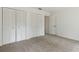 This bedroom features plush carpeting and double-door closets for ample storage space at 1870 S Lehigh Dr, Deltona, FL 32738