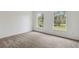An empty bedroom with natural light, plush carpeting, and neutral paint at 1870 S Lehigh Dr, Deltona, FL 32738