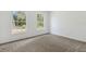 An empty bedroom with natural light and plush carpeting awaits personalization at 1870 S Lehigh Dr, Deltona, FL 32738