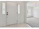 Bright entryway featuring a modern door and tile flooring, leading to a dining area at 1870 S Lehigh Dr, Deltona, FL 32738