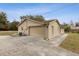Exterior showcasing a two car garage, driveway, and landscaping at 1870 S Lehigh Dr, Deltona, FL 32738