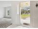 Open front door, a glimpse of the front yard, and an adjacent living room space at 1870 S Lehigh Dr, Deltona, FL 32738