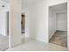 Bright hallway with tile flooring, leading to the kitchen and bedroom at 1870 S Lehigh Dr, Deltona, FL 32738