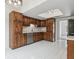 Updated kitchen showcasing wood cabinets, stainless steel appliances, and bright tile floors at 1870 S Lehigh Dr, Deltona, FL 32738