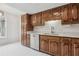 Kitchen featuring wood cabinets, stainless steel dishwasher, and white countertops at 1870 S Lehigh Dr, Deltona, FL 32738