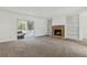 Inviting living room with brick fireplace, built-in shelves, and sliding glass door at 1870 S Lehigh Dr, Deltona, FL 32738