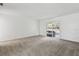 Spacious living room with neutral walls, gray carpet, and sliding glass doors at 1870 S Lehigh Dr, Deltona, FL 32738