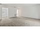 Expansive living room showcasing neutral walls and carpet with views to the outdoors at 1870 S Lehigh Dr, Deltona, FL 32738