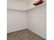 This walk-in closet offers a simple, functional storage space with neutral carpeting at 1870 S Lehigh Dr, Deltona, FL 32738