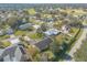 Aerial view showcasing a home in a community with a nearby golf course and mature trees at 1930 Seclusion Dr, Port Orange, FL 32128