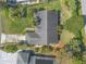 Top-down aerial view of a home featuring manicured lawn, garden beds, and a concrete driveway at 1930 Seclusion Dr, Port Orange, FL 32128