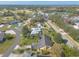 Drone shot of a house within a community with a golf course and nearby clubhouse at 1930 Seclusion Dr, Port Orange, FL 32128