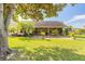 A spacious backyard with a covered patio, perfect for outdoor entertaining and relaxation at 1930 Seclusion Dr, Port Orange, FL 32128