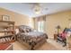 Cozy bedroom featuring a comfortable bed, a ceiling fan, and a wooden bookshelf at 1930 Seclusion Dr, Port Orange, FL 32128