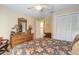 Comfortable bedroom with a floral bedspread and a charming dresser with a mirror at 1930 Seclusion Dr, Port Orange, FL 32128
