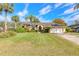 Charming single-story home with a well-manicured lawn and lush landscaping at 1930 Seclusion Dr, Port Orange, FL 32128