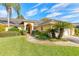 Inviting home exterior with a pathway leading to the front door framed by plants and trees at 1930 Seclusion Dr, Port Orange, FL 32128