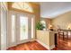 Inviting foyer with a decorative glass door and a view into the cozy sitting area at 1930 Seclusion Dr, Port Orange, FL 32128