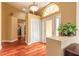 Bright foyer featuring wood floors, a decorative door, and a glimpse into the living spaces at 1930 Seclusion Dr, Port Orange, FL 32128