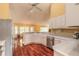 Bright kitchen featuring modern appliances, white cabinets and hardwood floors at 1930 Seclusion Dr, Port Orange, FL 32128