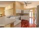 Well-lit kitchen boasts stainless steel appliances, white cabinetry, and hardwood floors at 1930 Seclusion Dr, Port Orange, FL 32128
