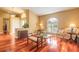 Comfortable living room featuring hardwood floors and ample natural light from large windows at 1930 Seclusion Dr, Port Orange, FL 32128