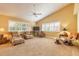 Inviting living room with carpet floors, vaulted ceilings, and sunlit windows, creating a cozy atmosphere at 1930 Seclusion Dr, Port Orange, FL 32128