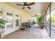Relaxing screened patio with neutral tile, fan and view to the yard at 1930 Seclusion Dr, Port Orange, FL 32128