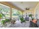 Relaxing screened patio with neutral tile, fan and view to the landscaped yard at 1930 Seclusion Dr, Port Orange, FL 32128