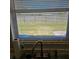 View of backyard through kitchen window with blinds at 213 Lone Pine Dr, Edgewater, FL 32132
