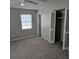 Bedroom with carpet, window, and built-in closet at 213 Lone Pine Dr, Edgewater, FL 32132
