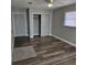 Well-lit bedroom with wood-look floors and a large closet at 213 Lone Pine Dr, Edgewater, FL 32132