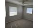 Spacious bedroom with carpeted floors and two windows at 213 Lone Pine Dr, Edgewater, FL 32132