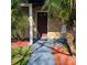 Brick home with a burgundy front door and walkway at 213 Lone Pine Dr, Edgewater, FL 32132